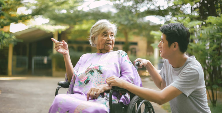 CALD senior womal with dementia in wheelchair