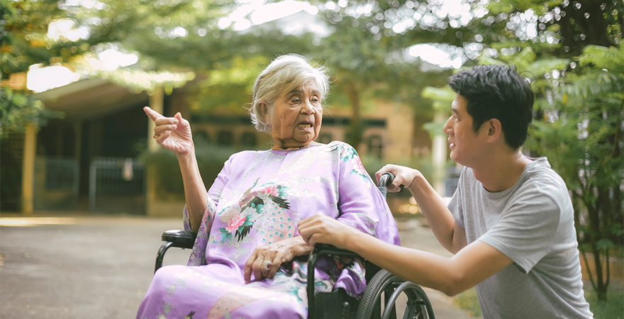 CALD senior womal with dementia in wheelchair