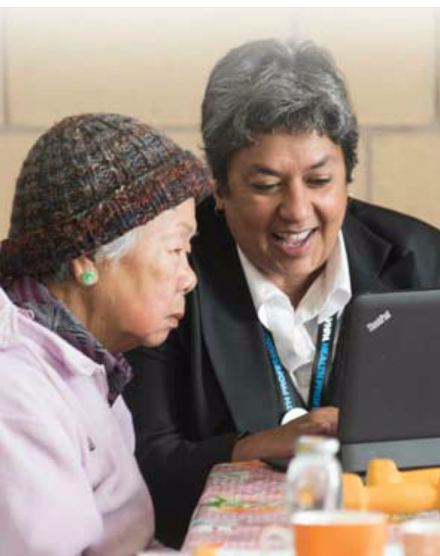 Two ladies sitting down at a computer